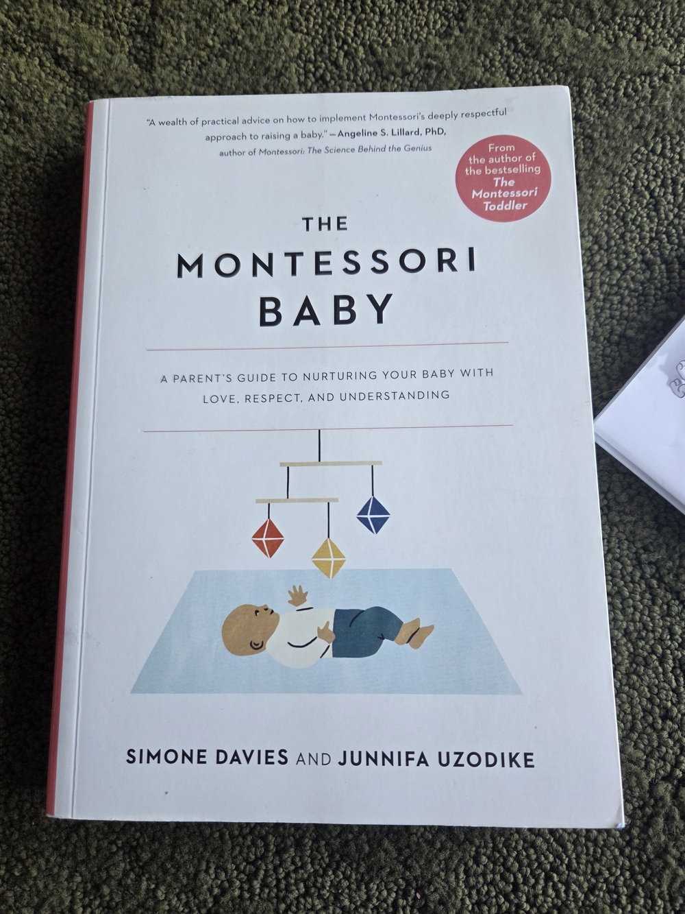 The Montessori Baby by Simone Davies - White Cover with Colorful Mobile